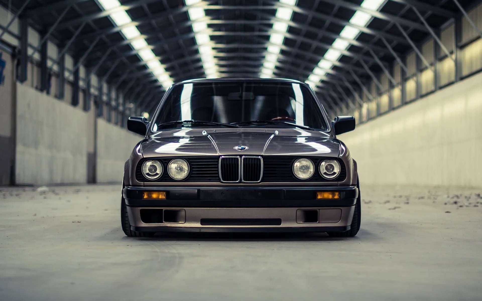 BMW E30 driving on a mountain road